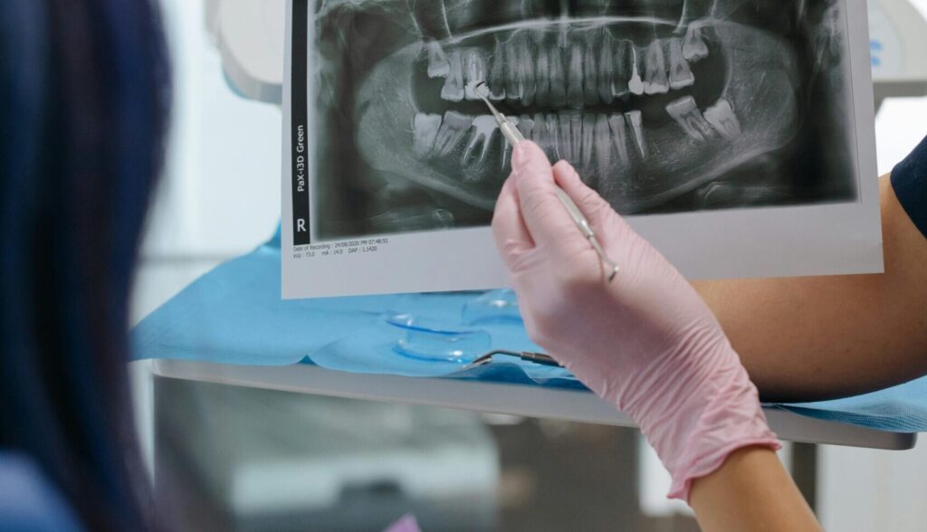 Dentist examining patient’s jaw alignment at The Dental Oracle clinic in Alabang.